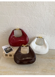 Detailed view of glossy leather crescent hobo bags in red, white and dark brown colors
