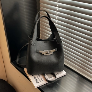 Classic black leather bucket bag with silver metal lock and adjustable shoulder strap