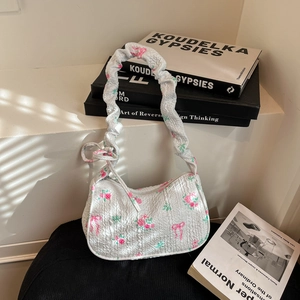 Floral print pleated underarm bag with pink butterfly patterns and scrunchie strap