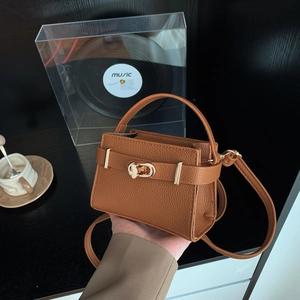 Minimalist brown litchi pattern flap bag with gold metal clasp and adjustable strap