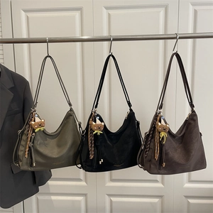 Three minimalist soft leather tote bags in olive, black, and coffee with bear charms