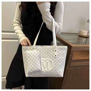 Dettaglio della borsa tote bianca con stampa M e piccola pochette coordinata con zip