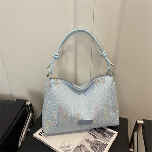 Light blue faux leather tote bag with rainbow embroidery and knotted handles for daily use