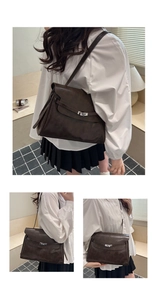Detail view of large dark brown retro tote bag with silver twist lock and adjustable strap