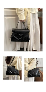 Detail of black glossy leather tote bag with silver metallic twist lock and handle