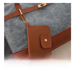 Detail of grey felt and brown leather tote bag with gold lock and mini charm