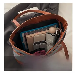 Interior view showing large capacity for tablet, umbrella, and books in tote bag