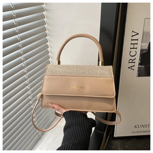 Detail of apricot crossbody bag featuring a shimmering rhinestone flap and gold logo