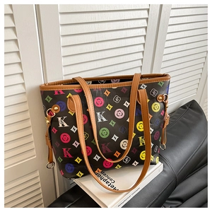 Detail of colorful geometric patterns and metal D-ring on a retro tote bag