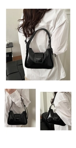 Three-way view of a sleek black patent leather baguette bag with silver hardware