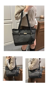 Close-up of grey frosted tote bag with black leather patchwork and golden twist lock