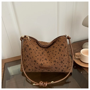 Detail of brown corduroy tote bag with bow print and leather Fashion brand label