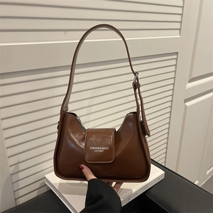 Minimalist deep brown leather shoulder bag with adjustable strap and embossed logo