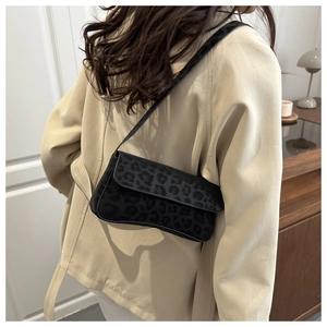 Chic black leopard print shoulder bag styled with a beige trench coat for a trendy look