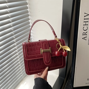 Dark red stone pattern crossbody bag with golden H buckle and cherry charm detail