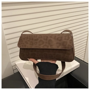 Close-up of leopard print shoulder bag with suede texture and rectangular flap design