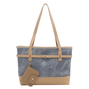 Large gray denim tote bag with leather trim, decorative belt buckle, and a matching coin purse