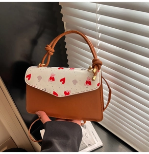 Detail of cute cherry crossbody bag with teddy bear pattern and leather handle