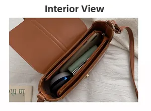 Detail view of the brown retro shoulder bag interior with multiple compartments