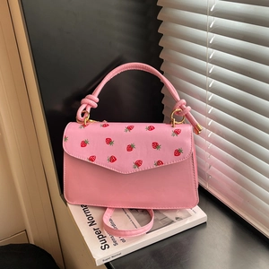 Pink sweet-style crossbody handbag with red strawberry print and gold hardware detail