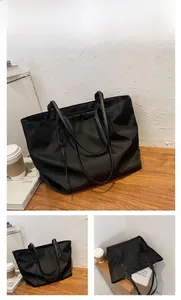Macro view of a black large capacity tote bag made of durable waterproof nylon fabric