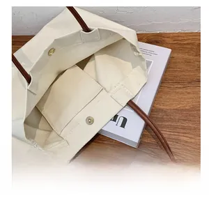 Internal view of canvas tote bag showing magnetic snap closure and inner pocket