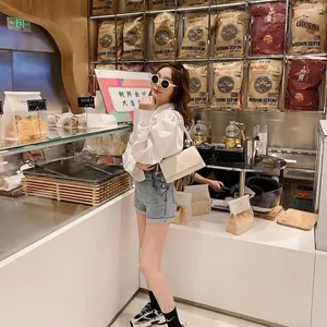 Minimalist beige leather underarm square bag with flap closure for women casual style