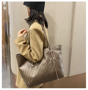Detail of large woven tote bag in metallic finish showing texture and spacious design