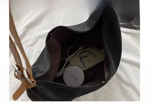 Detail view showing large capacity nylon bag interior with phone and cosmetics