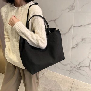 Minimalist large black canvas tote bag for women, ideal for daily commute and shopping