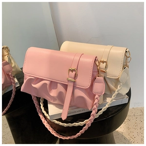 Detail of pink and beige pleated shoulder bags with woven straps and golden buckle