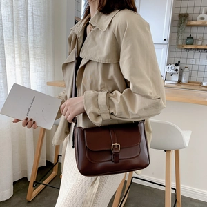 Minimalist dark brown rectangular crossbody bag with a flap and gold buckle detail