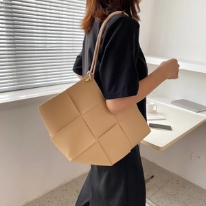 Minimalist beige woven leather large capacity tote bag shown on model for daily lifestyle