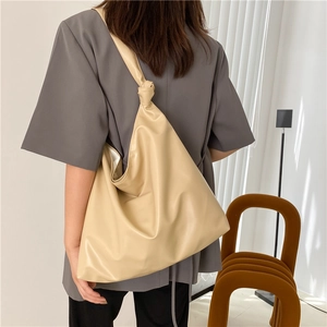 Minimalist beige PU leather hobo bag with large capacity and knot detail shoulder strap