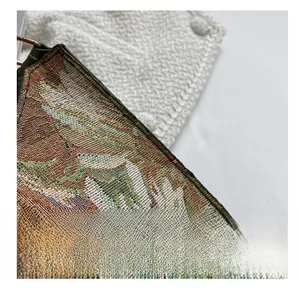 Close-up of precise stitching on vintage floral tapestry shoulder bag with leather trim