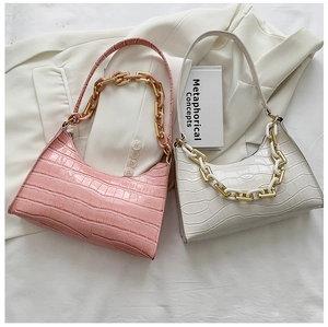 Pink and white baguette bags with crocodile texture and decorative thick chains