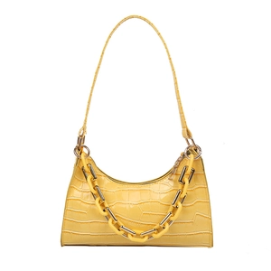 Fashionable bright yellow baguette shoulder bag with crocodile pattern and chunky chain link