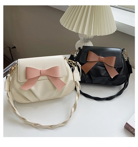 Détail de sacs plissés élégants avec décoration de nœud contrasté et bandoulière tissée