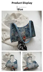 Detail view of blue floral jacquard underarm bag with crescent shape and leather shoulder strap