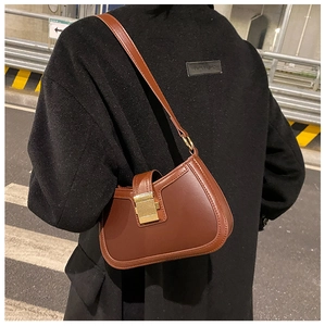 Brown vintage leather shoulder bag featuring a classic gold square metal buckle detail