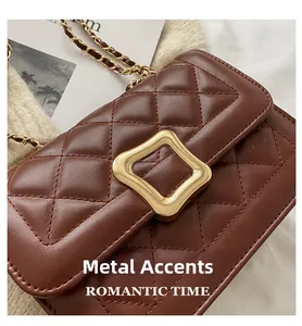 Detail of dark brown quilted crossbody bag with gold metal hardware and chain strap
