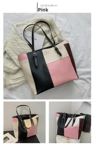 Detail view of pink and beige patchwork tote bag with adjustable leather shoulder straps