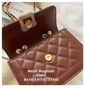 Detail of a brown quilted leather crossbody bag with a gold magnetic closure
