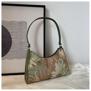 Macro detail of French vintage floral jacquard fabric and olive green leather strap