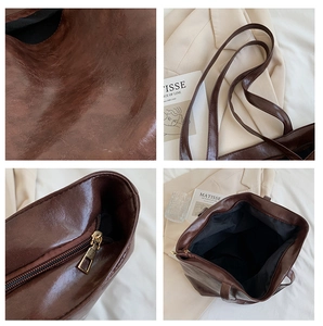 Détails de la texture du cabas marron, fermeture dorée et compartiment intérieur spacieux
