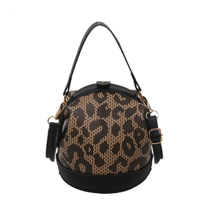 Vintage leopard print cylinder handbag with black handles and gold-tone metal hardware