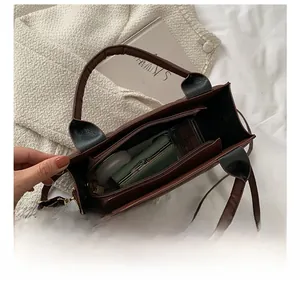 Macro view showing internal compartments and large capacity of this brown tote bag
