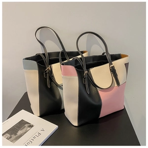 Detail view of contrast color tote bags featuring adjustable shoulder straps and metal buckles