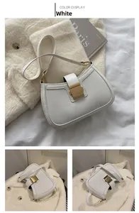 Close-up of white PU leather underarm bag with gold buckle and adjustable strap