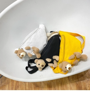 Detailed view of canvas waist bags in three colors with cute 3D plush bear charms
